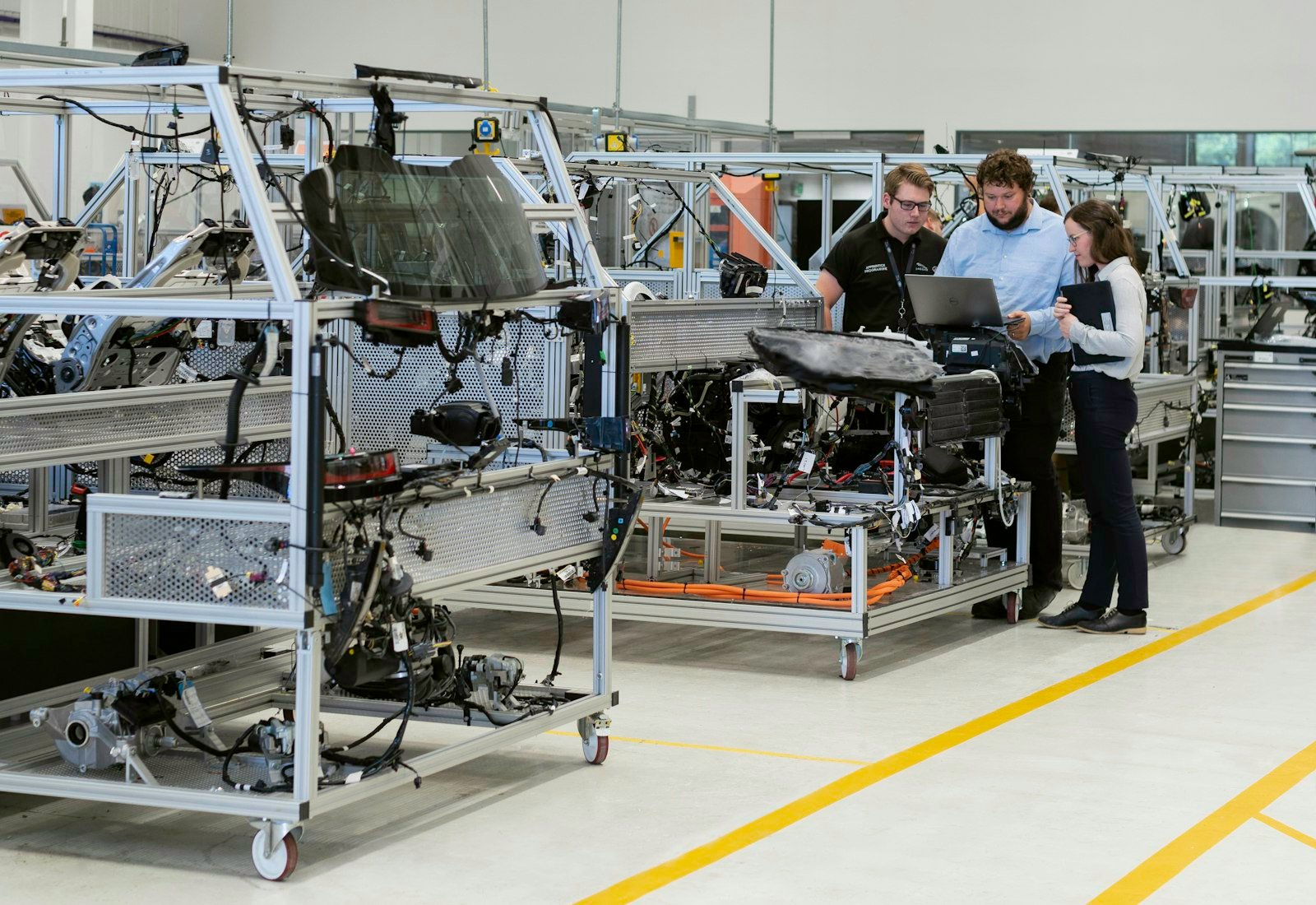 Engineers working on an automotive factory production line