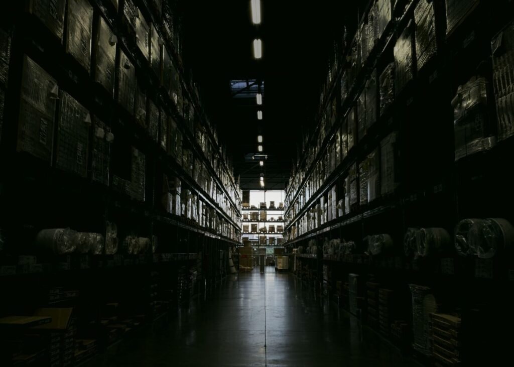 Warehouse aisle with tall shelves of marketplace stock
