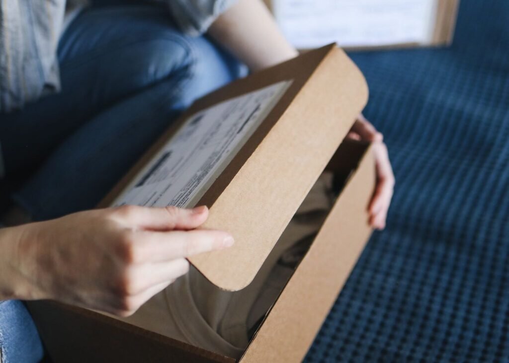 Customer sealing a delivery box at home