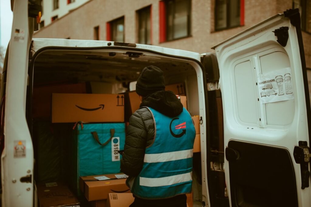 Delivery driver at the rear of a courier van