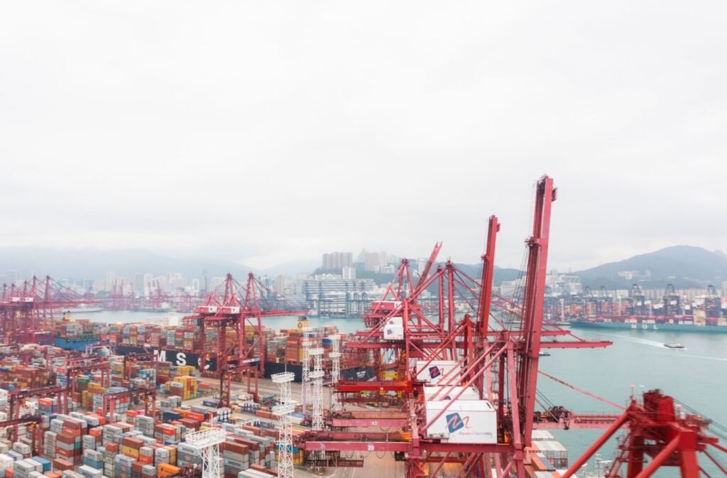 Cranes and shipping containers at a busy regional harbour