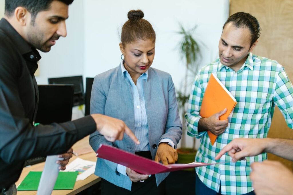 Compliance manager holding a folder of market documentation