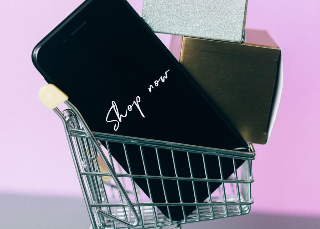 Smartphone resting on a miniature shopping trolley