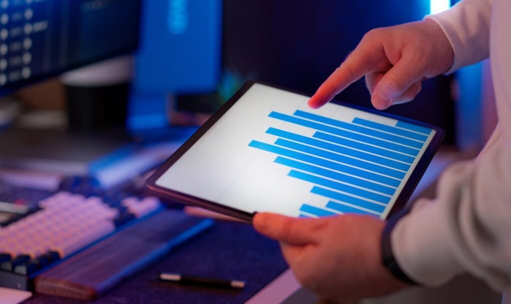Marketer reviewing a performance bar chart on a tablet