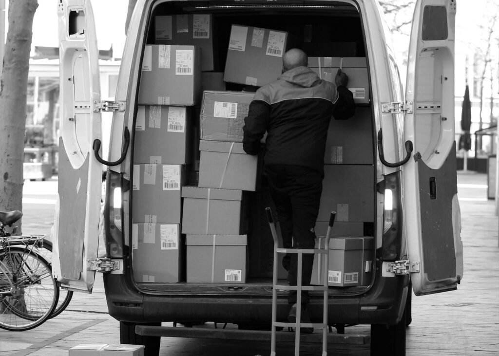 Driver arranging parcels inside a delivery van