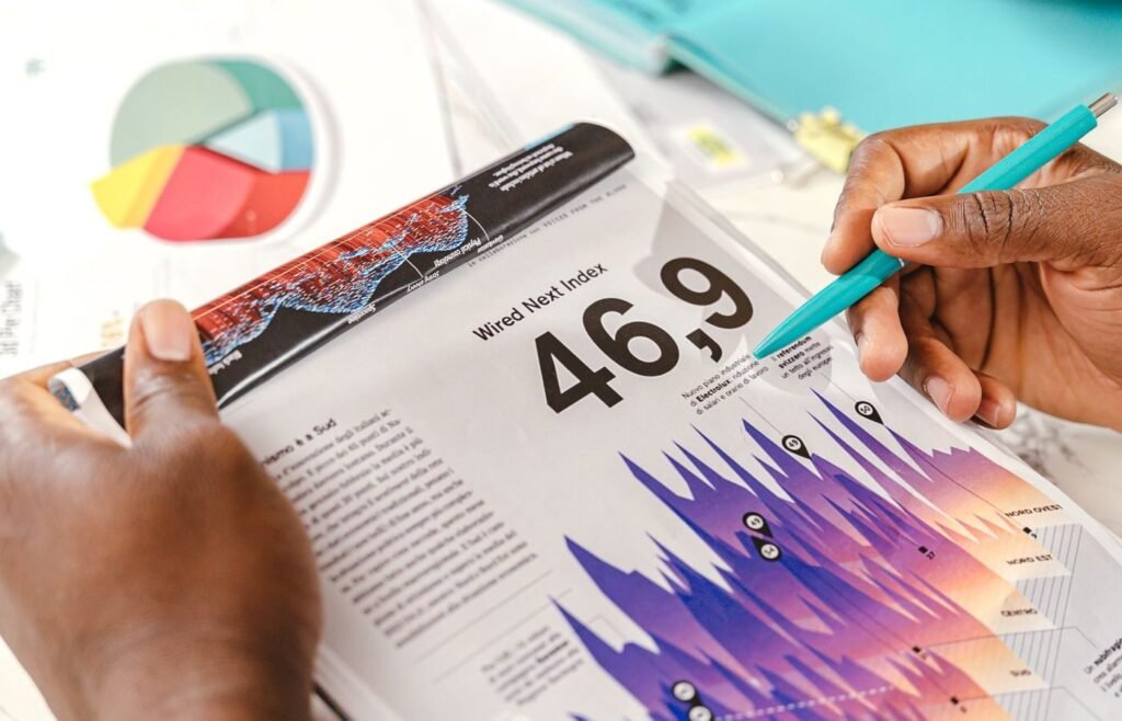 Hands pointing at printed data charts while a team works through audit findings