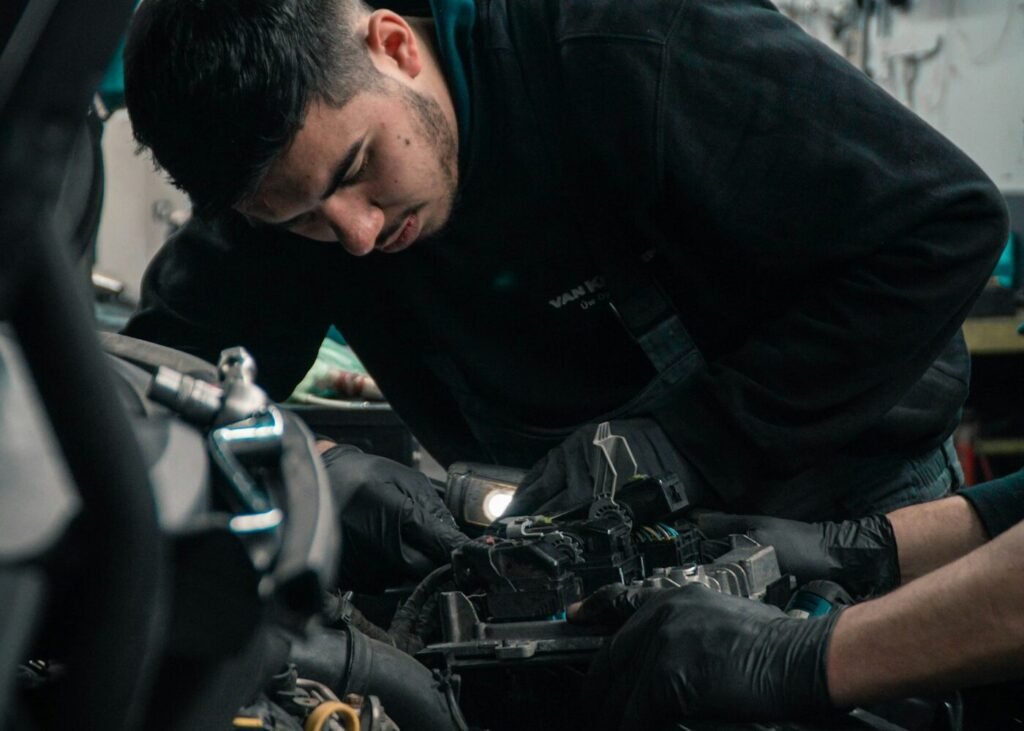 A mechanic working on a car engine