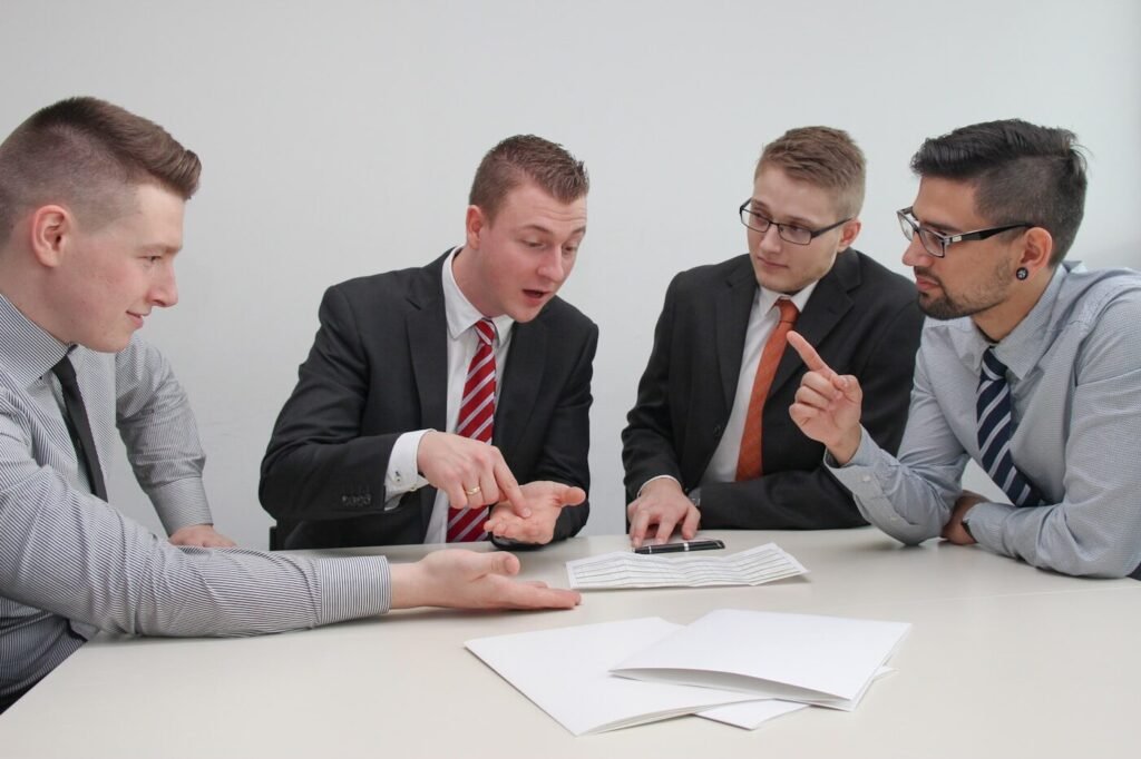 A procurement team meeting around a desk