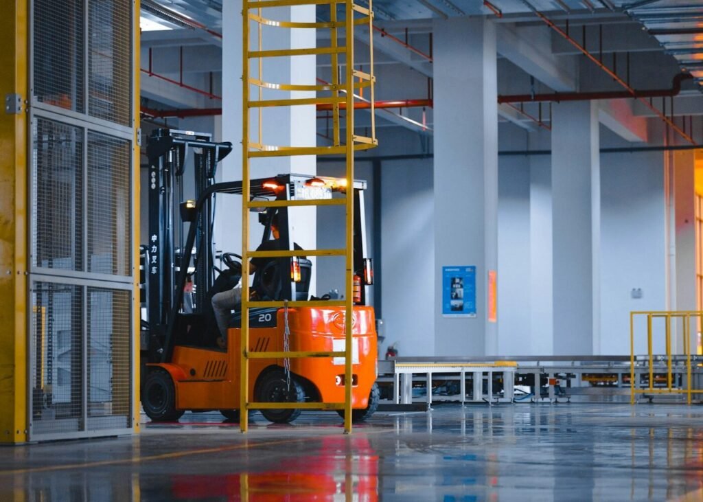 A forklift parked inside a large warehouse