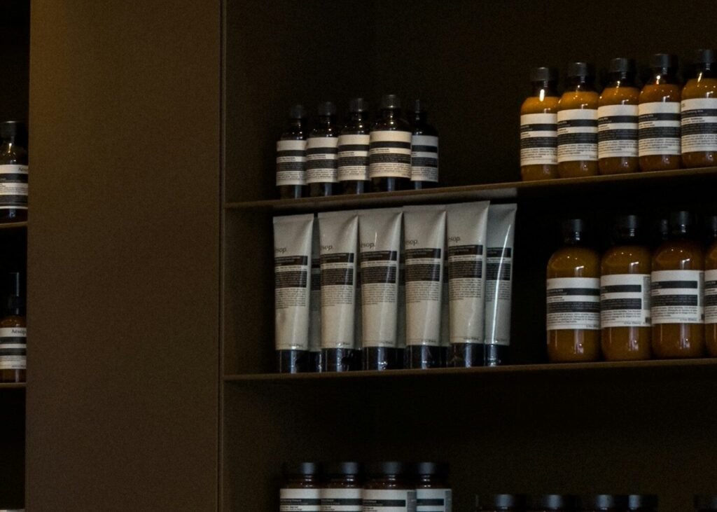 A shelf lined with bottles of beauty products