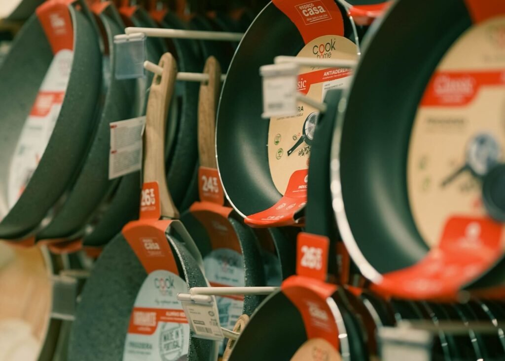 Range of non-stick frying pans on a retail display