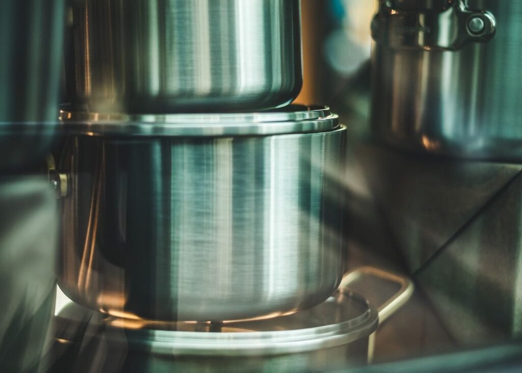 Stack of stainless steel cooking pots ready for despatch