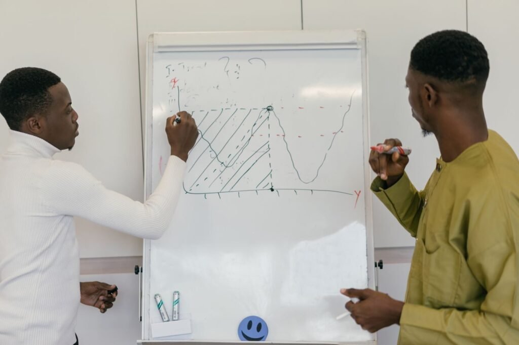 Colleagues analysing marketplace data on a whiteboard