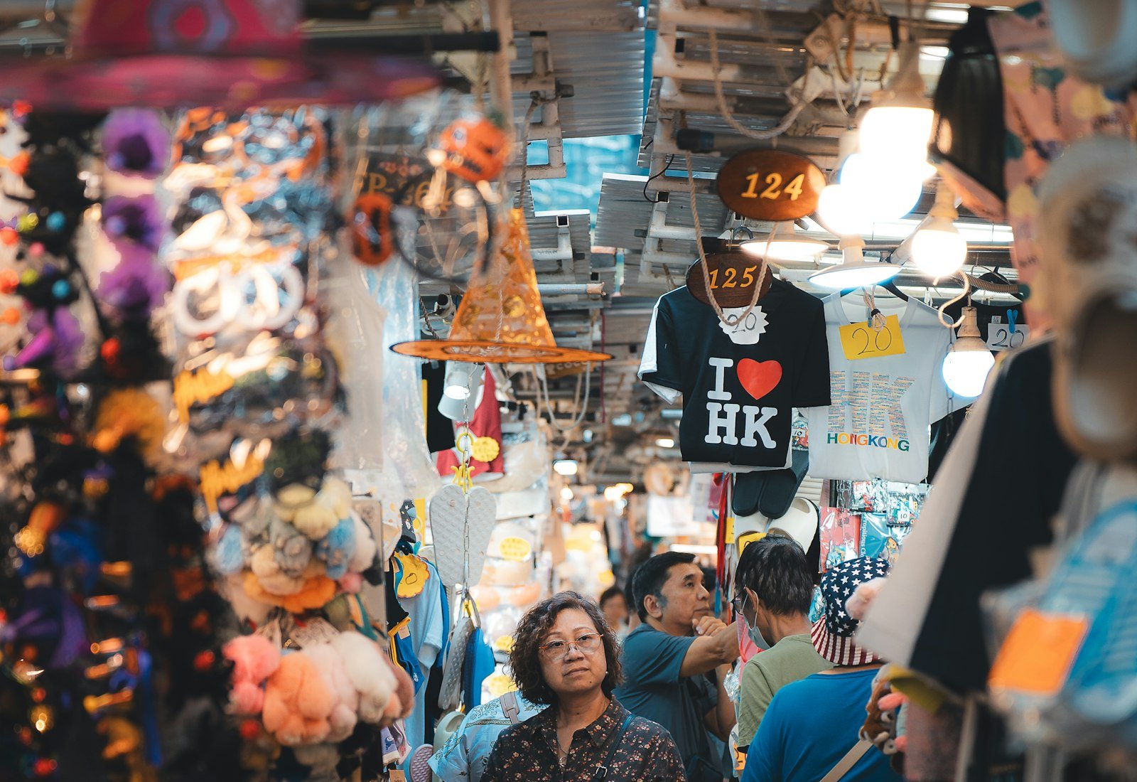 Shopper walking through a busy South Asian market stall