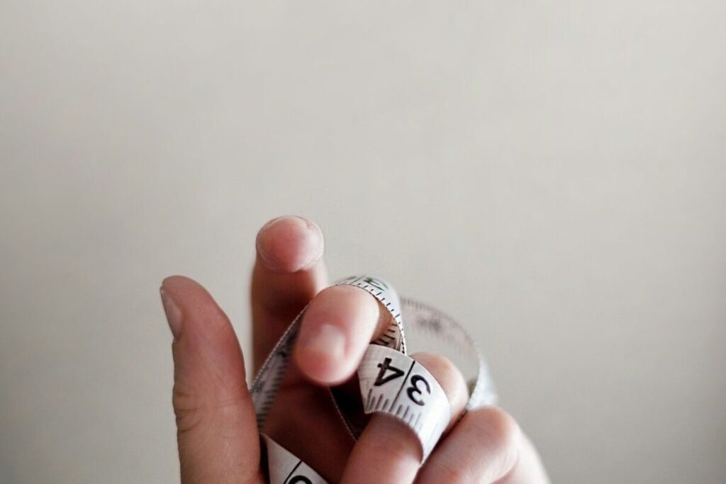 A tape measure wrapped around a hand for scale