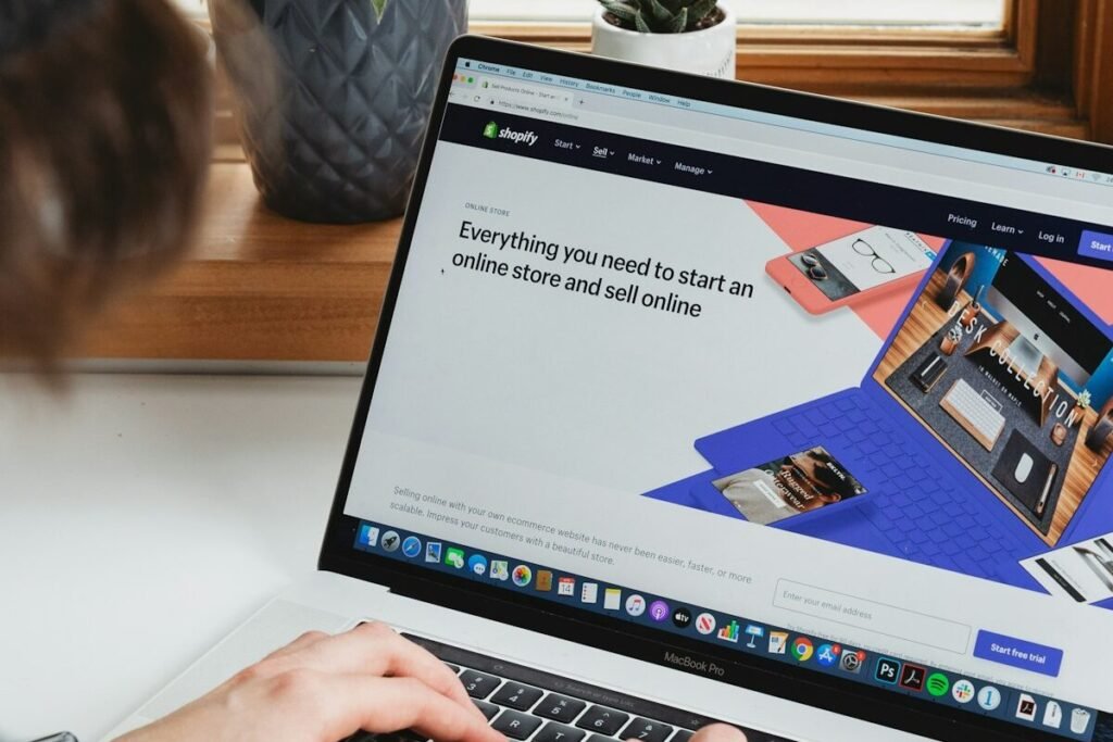 A laptop open on a white desk