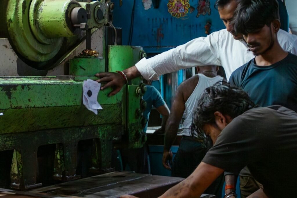 Operators running heavy machinery in a factory