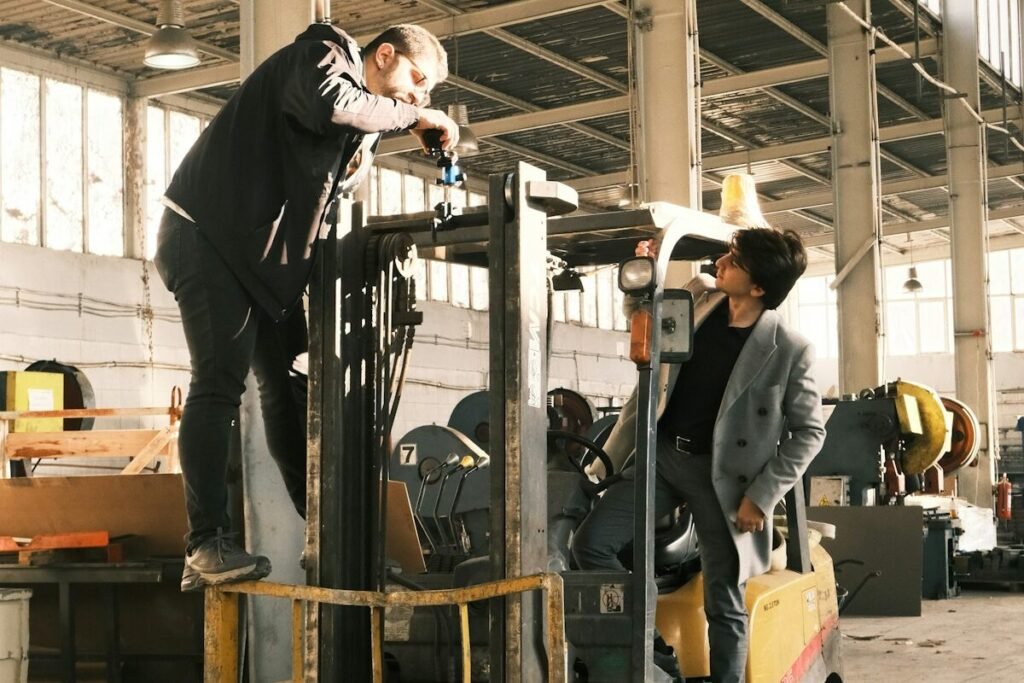 A worker on a forklift inside a warehouse
