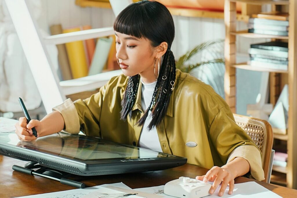 An artist working on a digital tablet in a studio