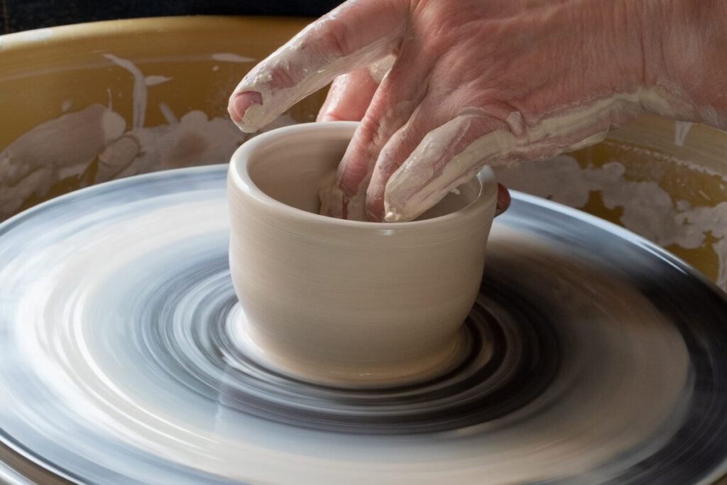 A handmade pot taking shape on the wheel