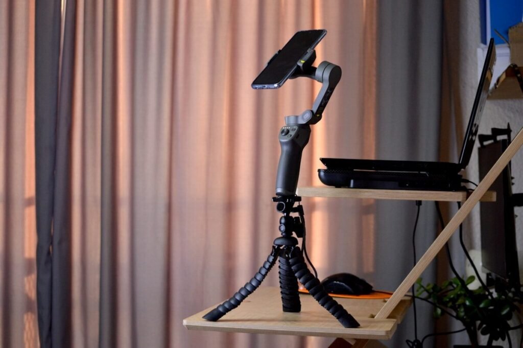 A camera on a tripod in front of a window