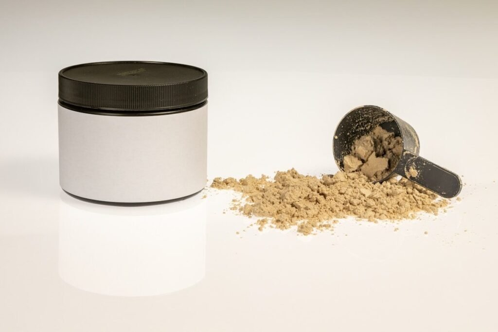 A powder jar photographed with its scoop