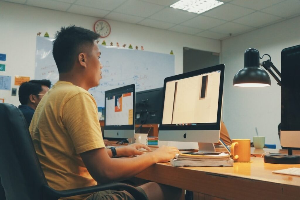 Two people reviewing a design on a desktop screen