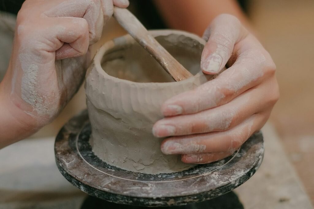 A maker throwing a clay vase