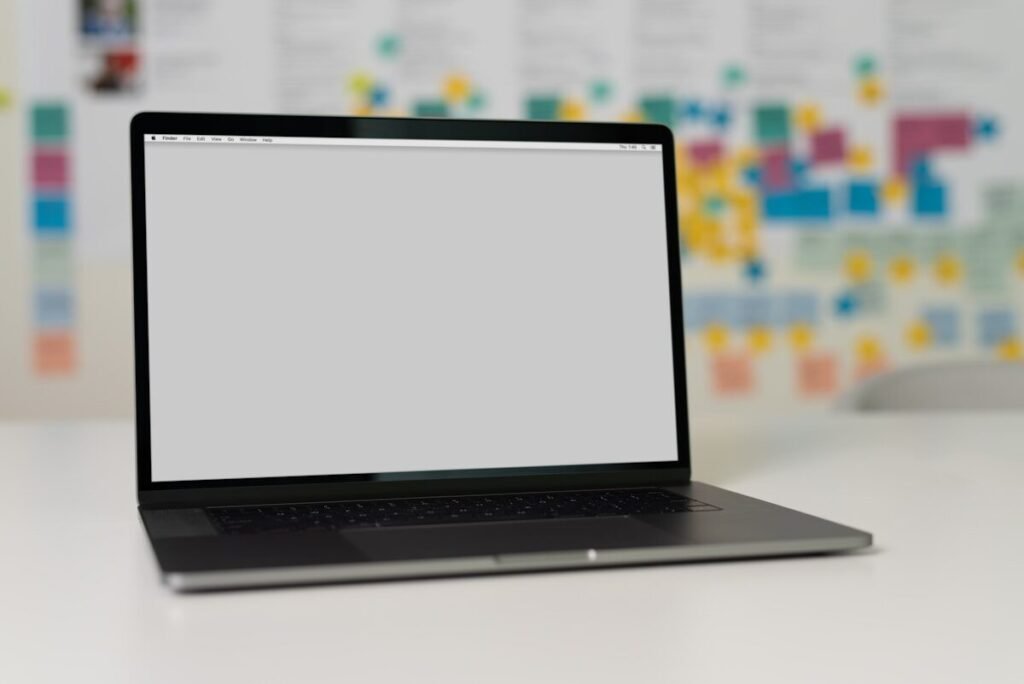 A laptop open on a white table