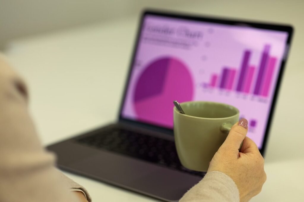 Working on a laptop beside a cup of coffee
