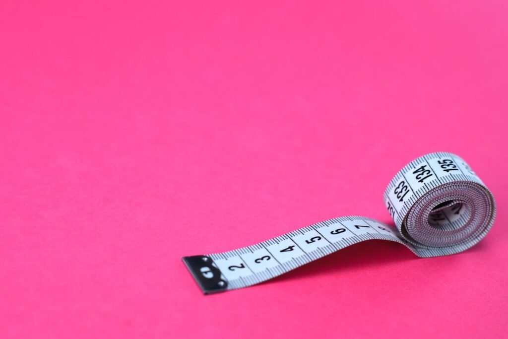 A tape measure on a plain background