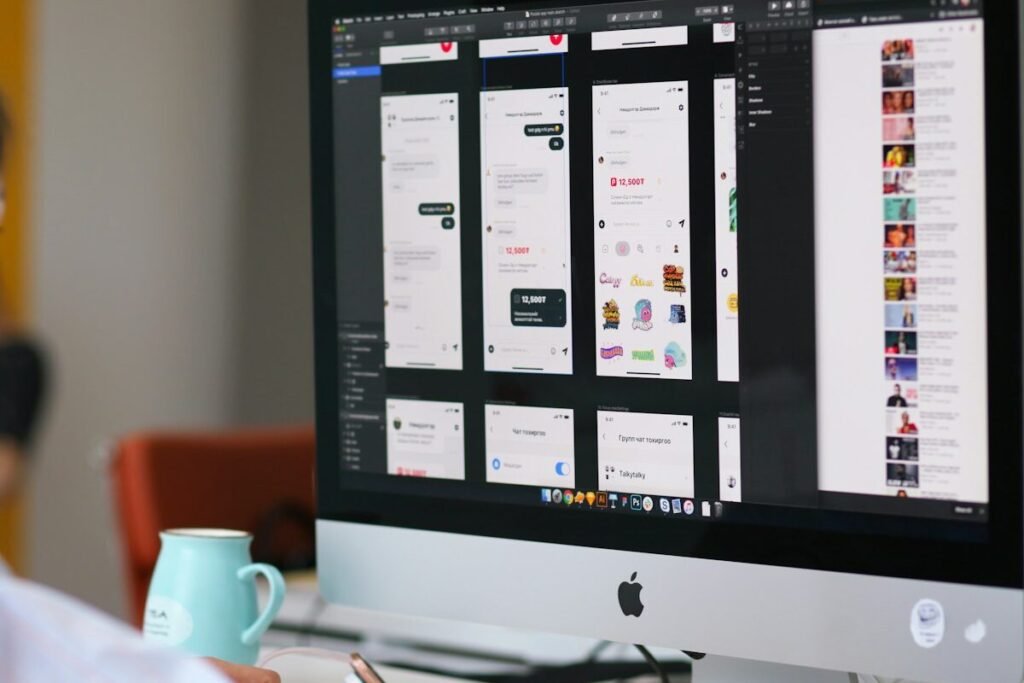 A large monitor on a wooden studio desk