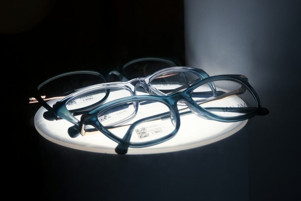 Eyeglasses arranged on a lit retail display