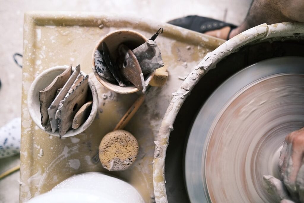 Shaping clay on a potter’s wheel