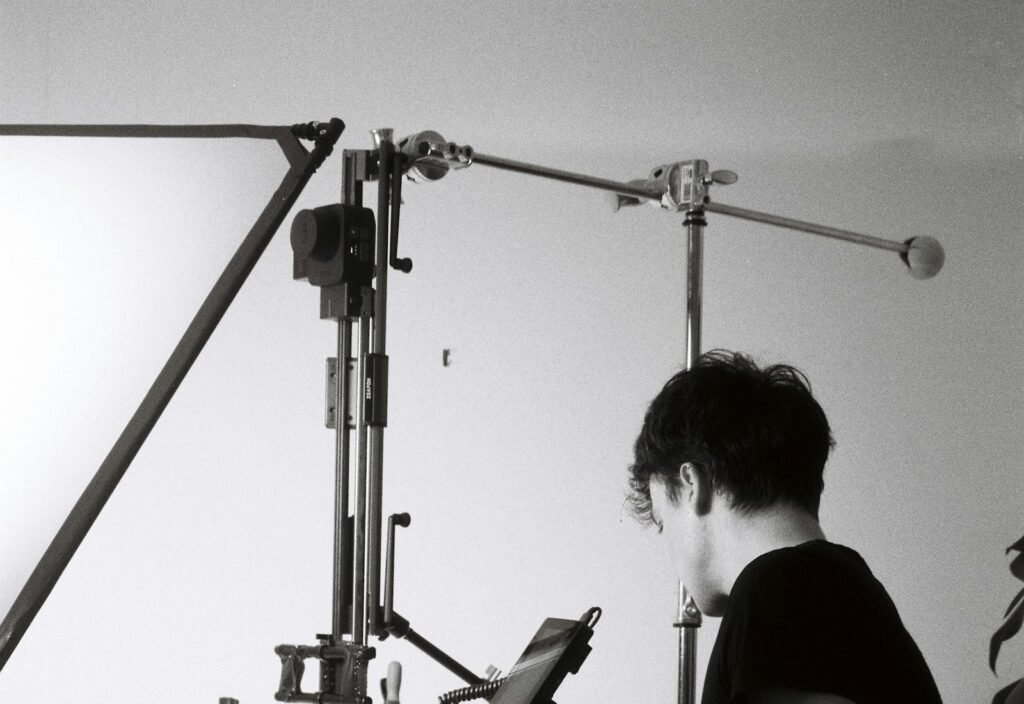 Photographer setting up studio lighting for product photography