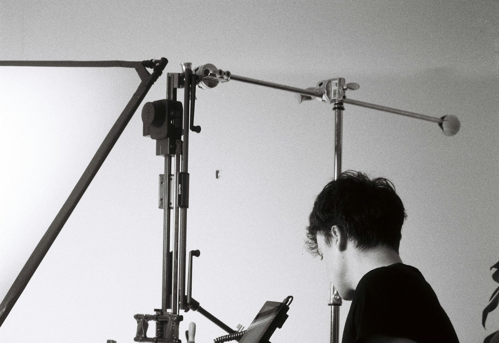 Photographer setting up studio lighting for product photography
