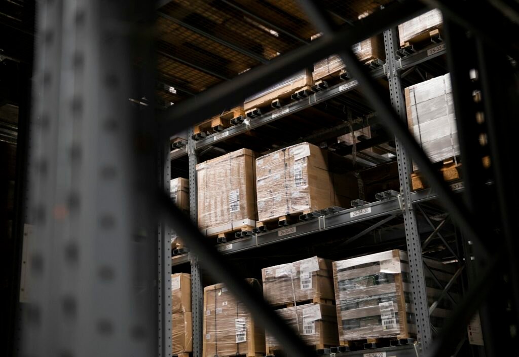 Warehouse aisle stacked with boxes and pallets
