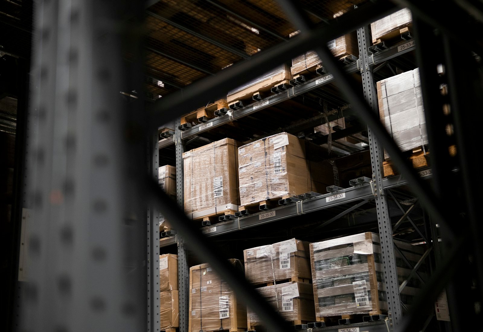 Warehouse aisle stacked with boxes and pallets