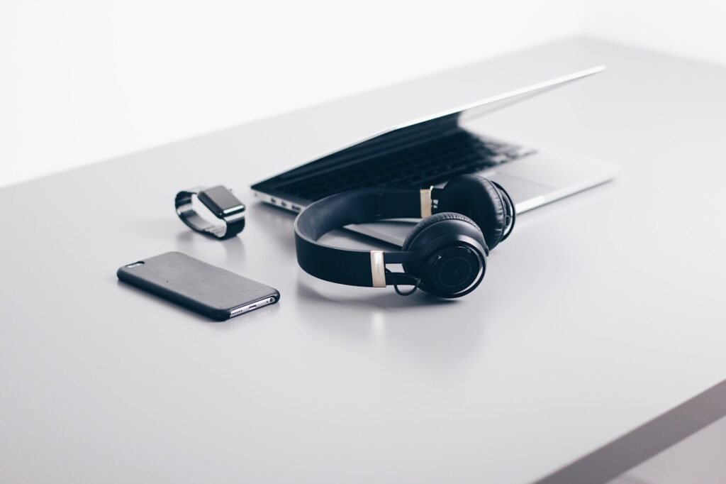 Wireless headphones beside a closed laptop