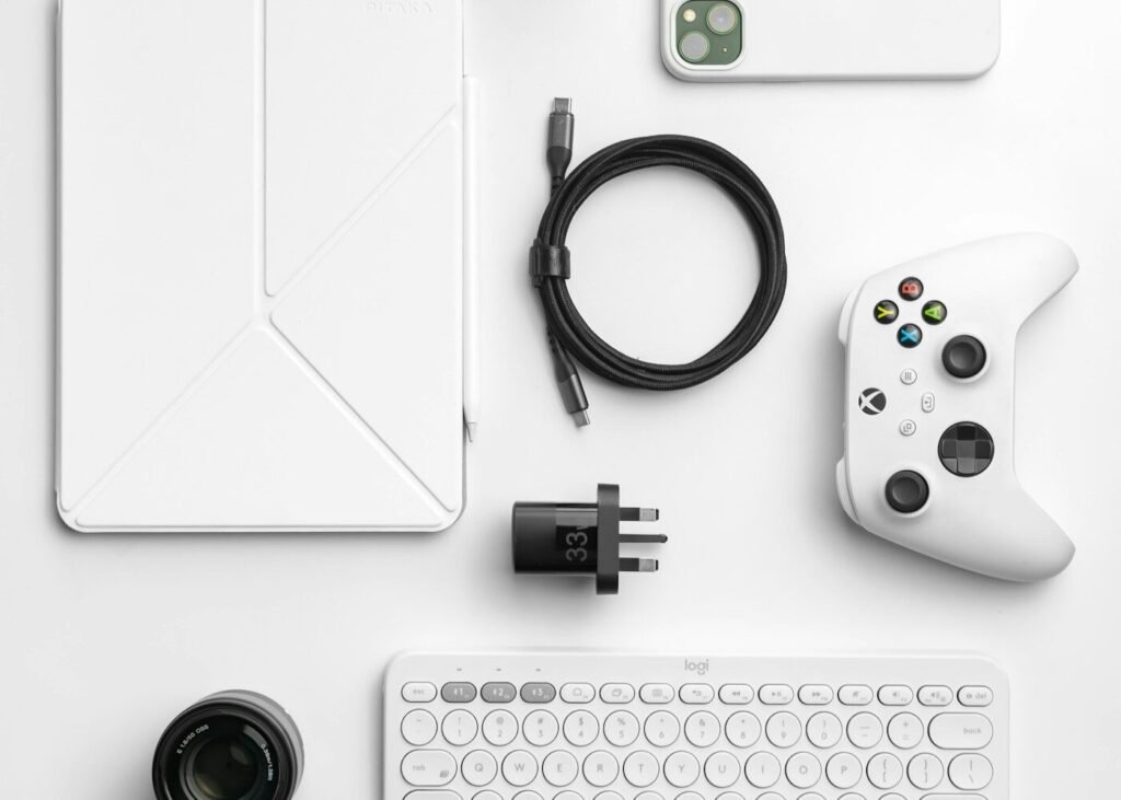 A white desk with a keyboard, mouse and other devices