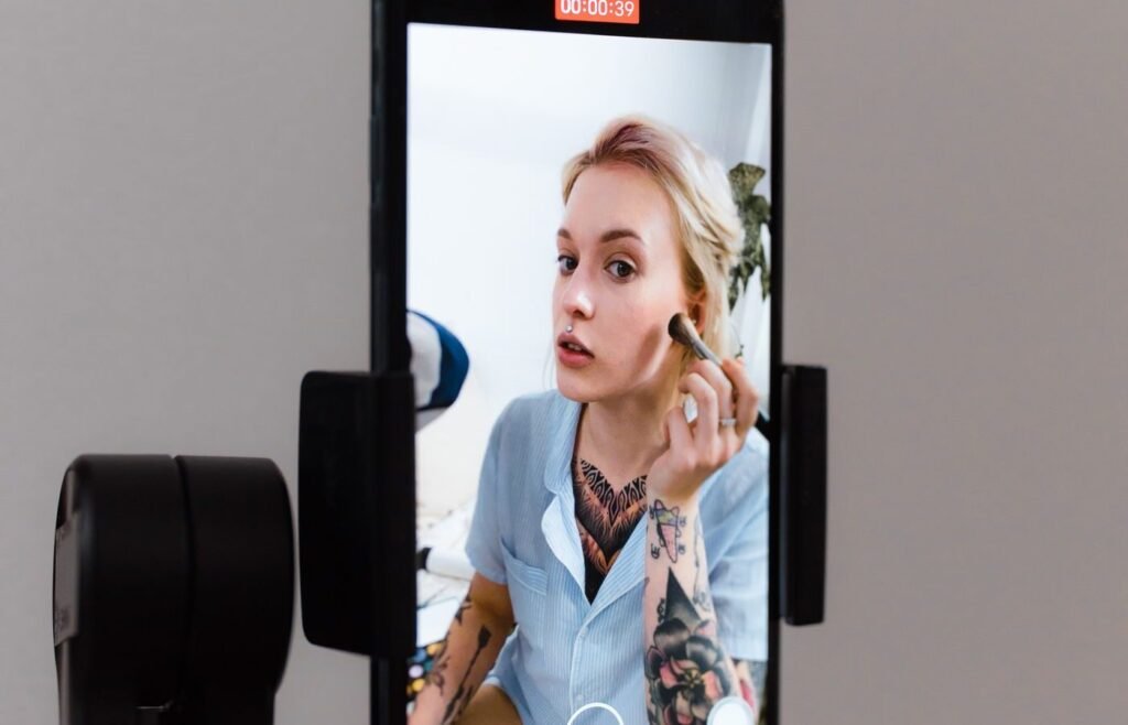 Creator recording a product video on a smartphone gimbal for paid social advertising