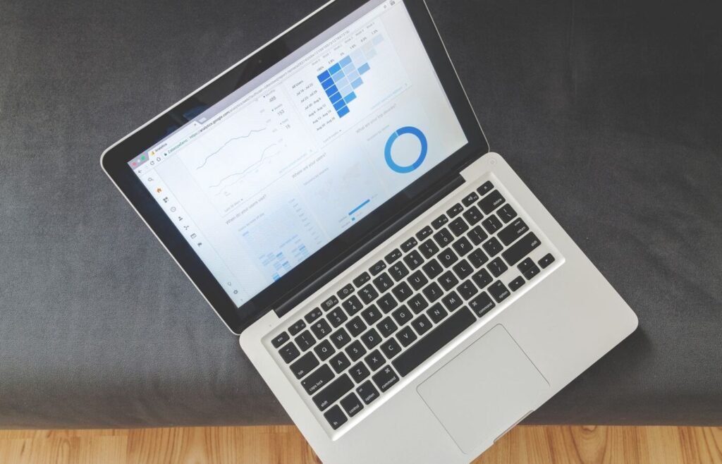 Overhead view of a laptop showing paid media performance charts