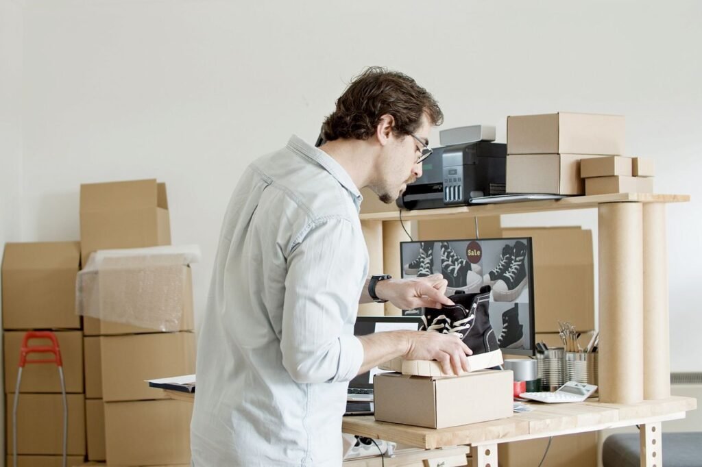 Business owner packing an order into a cardboard box
