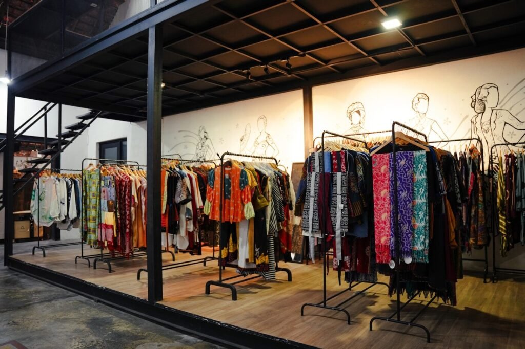 Rails of colourful garments in a fashion boutique