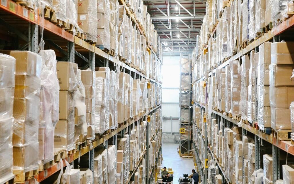 Cartons stacked on racking inside a fulfilment centre, where FBA storage and picking fees are incurred