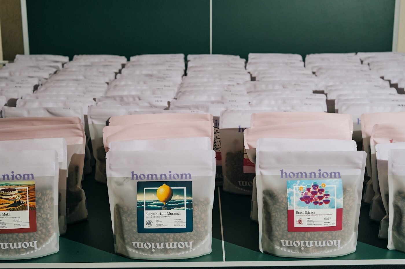Bags of roasted coffee lined up on a shelf