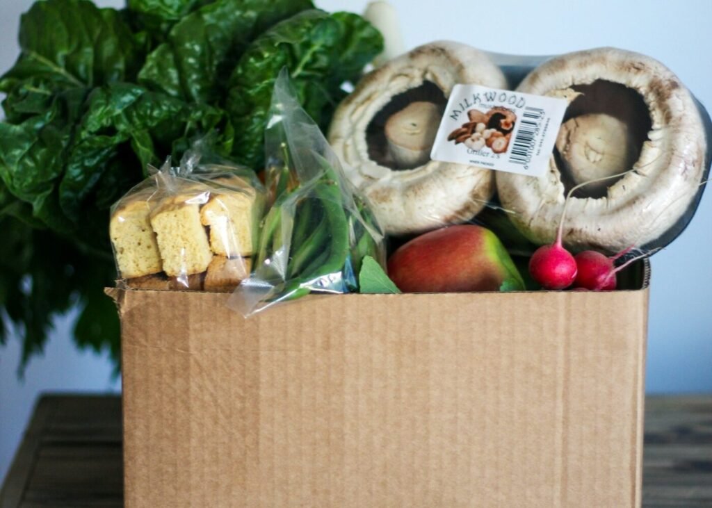 A box of groceries packed on a wooden table