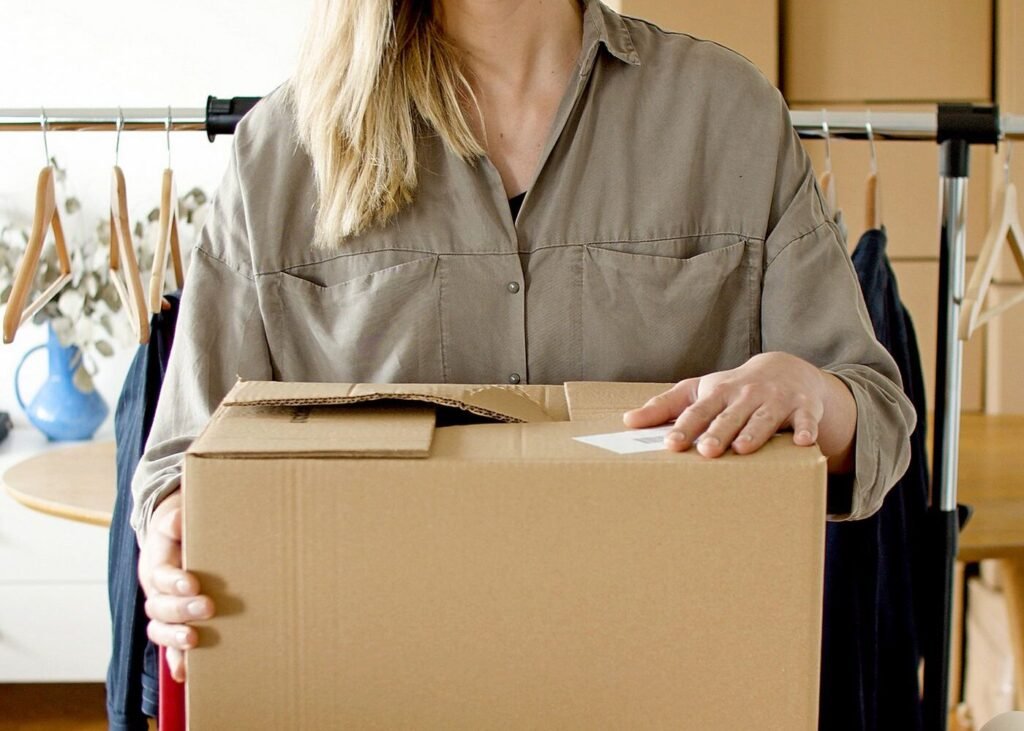 Online store owner holding a packaged customer order