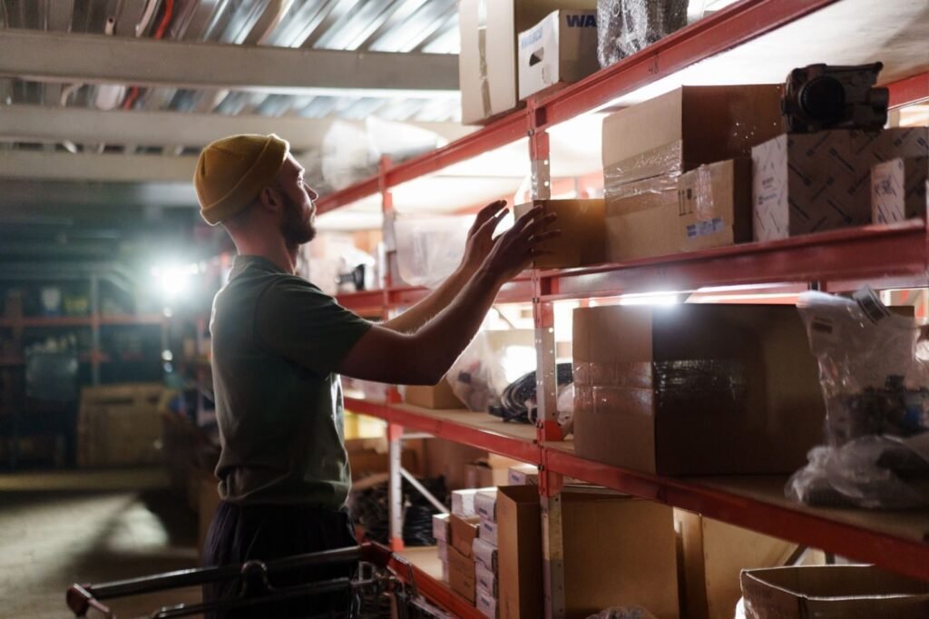 Warehouse worker organising marketplace stock on shelves