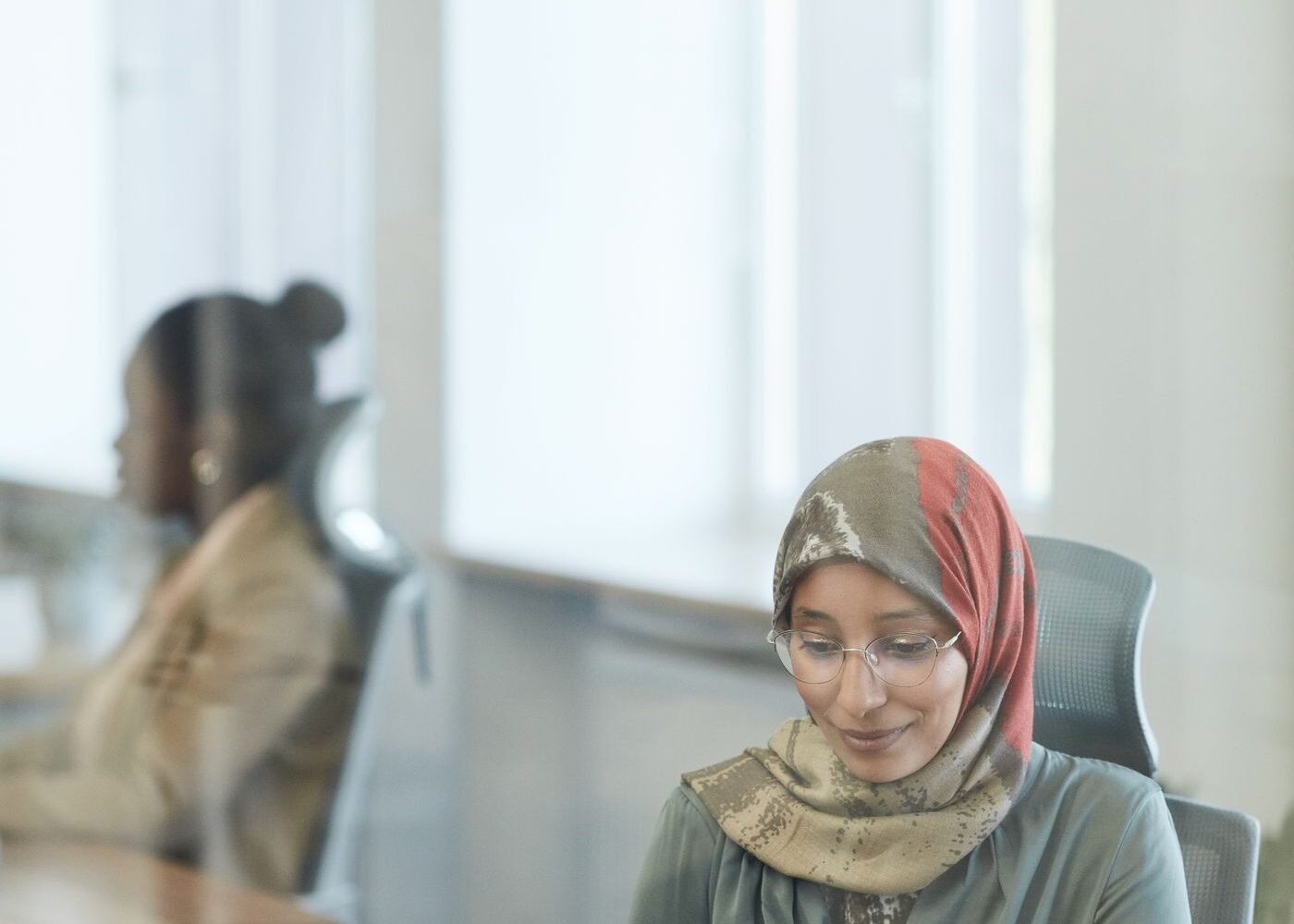 Businesswoman working on a laptop in a modern Gulf office